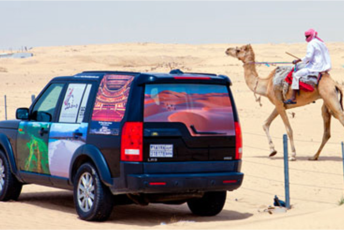 Passing slow moving traffic on the road across the Saudi desert